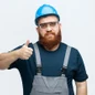 e25142b5-45b9-4089-867f-060e85cf8bff-confident-young-male-construction-worker-wearing-safety-helmet-uniform-safety-glasses-looking-camera-showing-thumb-up-isolated-white-background_141793-132415.jpg